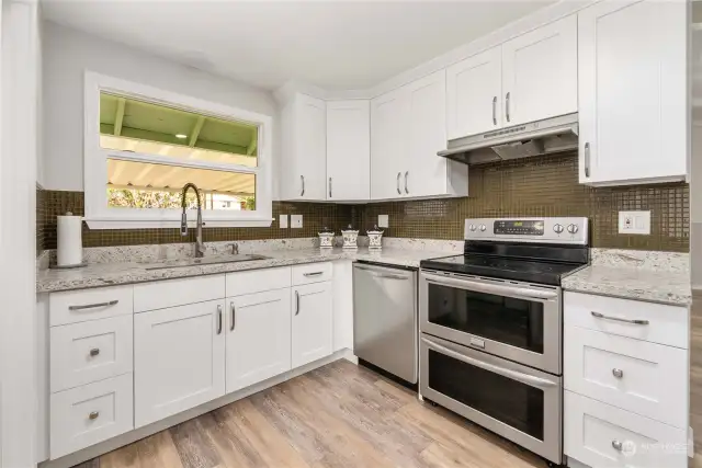 Beautiful updated kitchen with a double oven and a peaceful view looking out over the backyard. The kitchen light also turns on automatically when you enter the room.