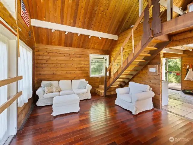 Living room with vaulted ceilings and wood flooring.