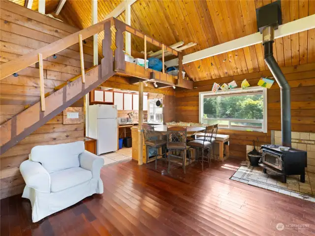 Living and dining rooms with wood stove for a cozy setting.