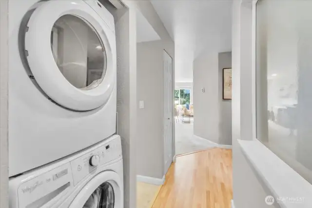 Hallway to entry with full-size washer and dryer
