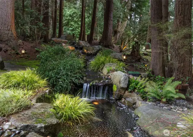 Koi pond at the end of a stream greets you as you enter this spectacular home.