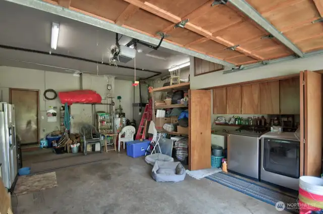 Garage interior with water heater and laundry hook ups. (W/D do not convey)