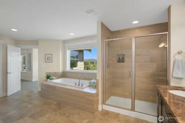 primary bathroom with tub and shower
