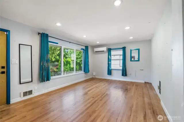 Front room with mini split and hardwood floors
