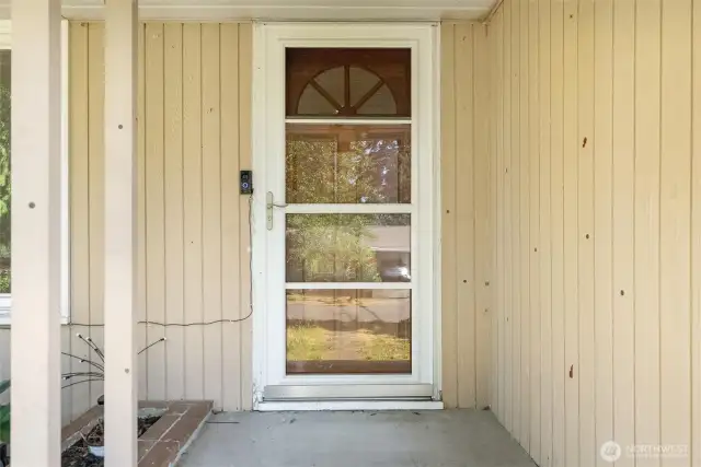 Storm door with built in screen