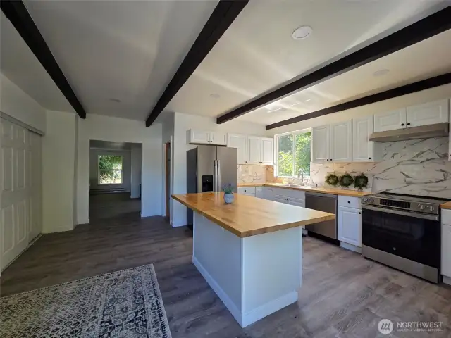 Love the wood beam ceilings & butcher block countertops!