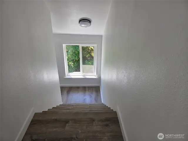 Extra wide stairs w/ample light.