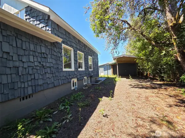 Off other side of front driveway leads to the back carport/ garage area.