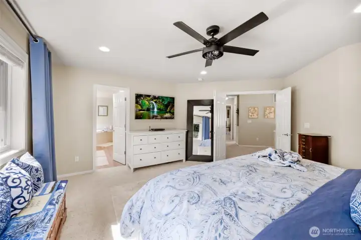 Primary bedroom looking into massive 5 piece bathoom
