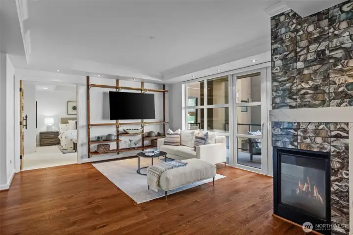 Simply stunning! Rich hardwoods, a striking feature fireplace wall, and abundant natural light create a warm and inviting atmosphere.