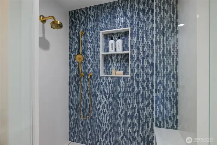 Step into luxury with this elegant tile shower featuring sleek modern fixtures.