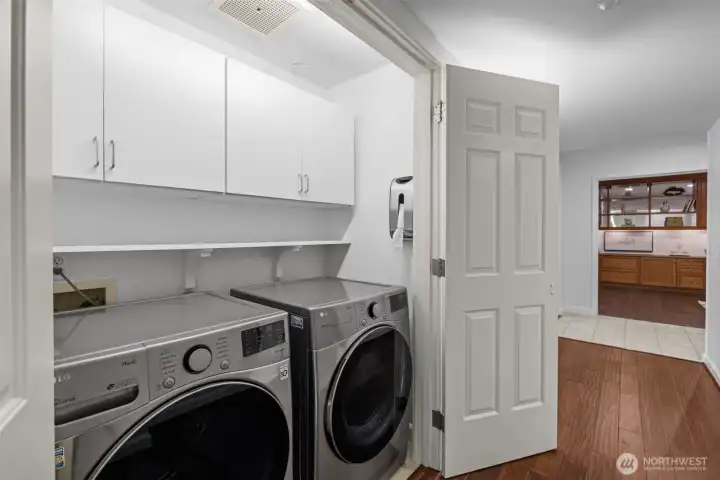 Conveniently located in-unit laundry featuring extra storage for all your essentials