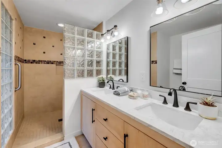 Spa-Inspired Ensuite Bath, Dual vanities, marble-style counters, and contemporary fixtures bring a touch of luxury to your daily routine.