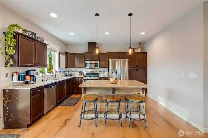 Featuring soft-close cabinetry, slab granite countertops, ample cabinet space...