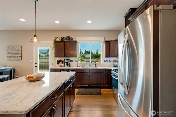 Slab granite island, tile backsplash & stainless-steel appliances...