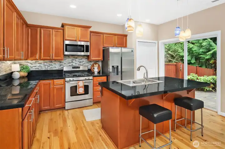 Kitchen with center island, stainless appliances, plenty of cabinet storage and pantry.