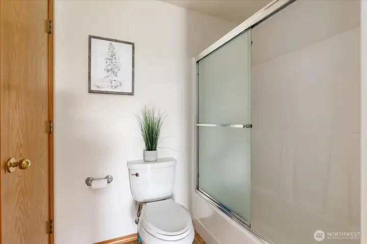 Shower and tub in hallway bathroom.