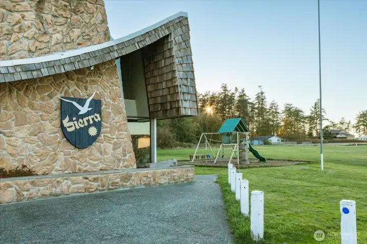 Sierra Club House with play structure beside it. This space can be rented for members parties!