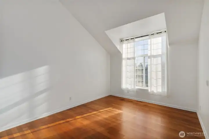 Spacious front living space with large bay windows to allow natural light to bathe the space