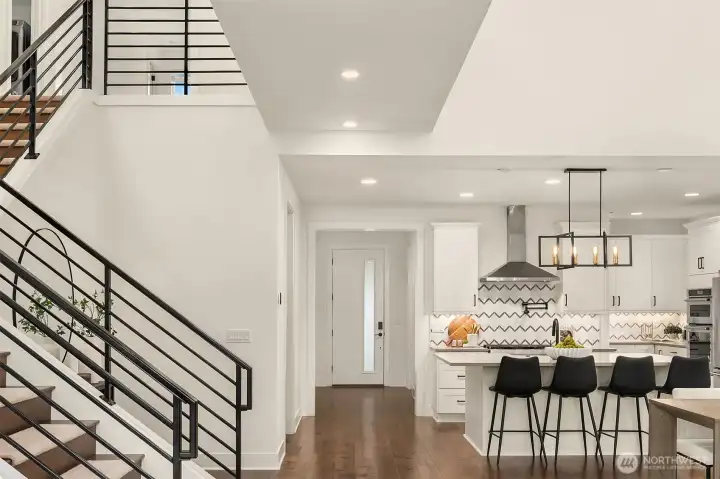 Stairway to second floor, entrance and kitchen area