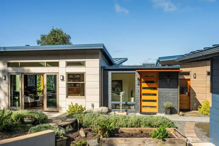 Sustainability drove many of the design choices of this recent build: fire retardant Swisspearl fiber cement and Vermont slate siding, a metal roof, and a 39 panel solar array.