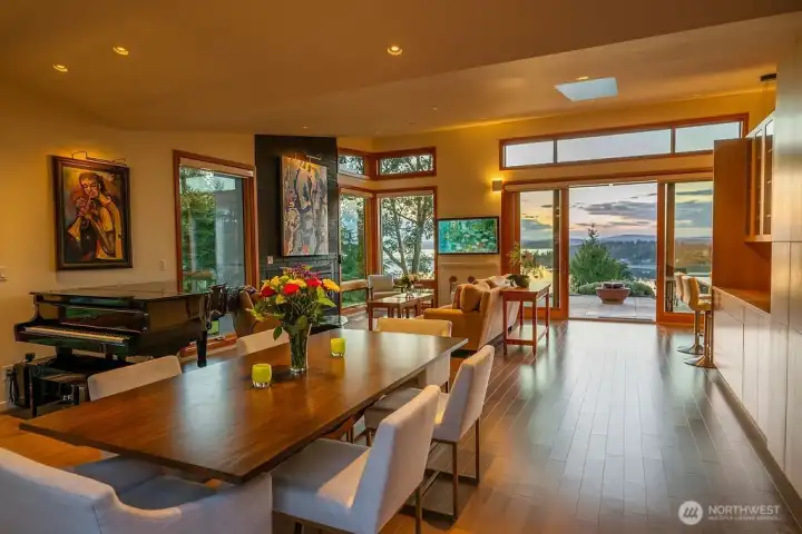 The living/dining area lit up by the golden hour, with the doors open to the patio.