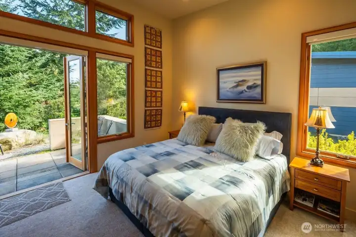 Second en suite bedroom on main floor with private patio.