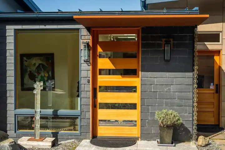 Thoughtful modern design and artistic touches are found throughout this home, including the Corten steel awning over the front door.