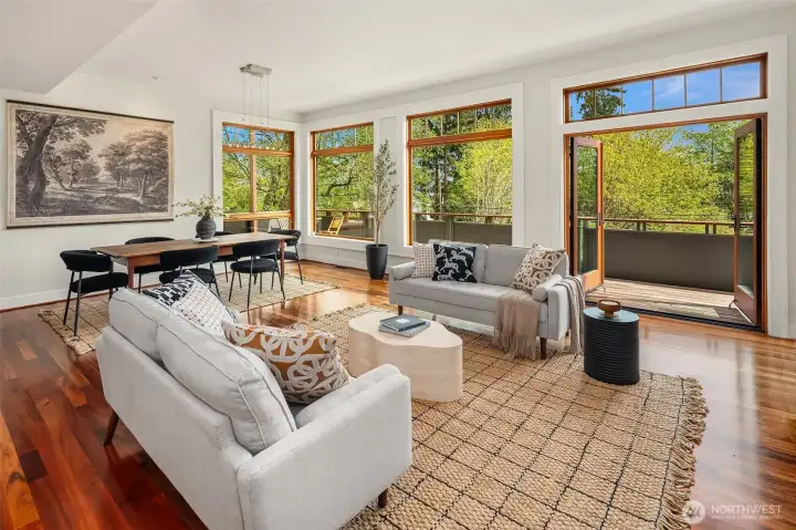 A palatial dining/living room with a wall of fir-trimmed windows faces the NE, with views to the sound, cascades and beyond.