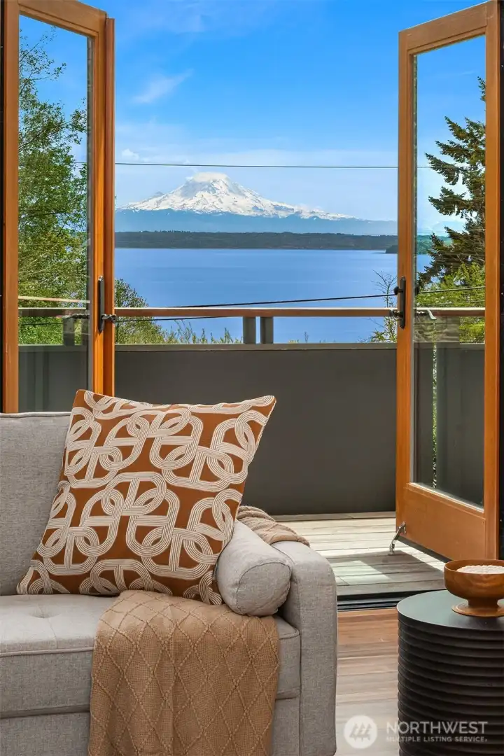 French doors from the living room lead to a spacious deck which expands across the entire front of the home.