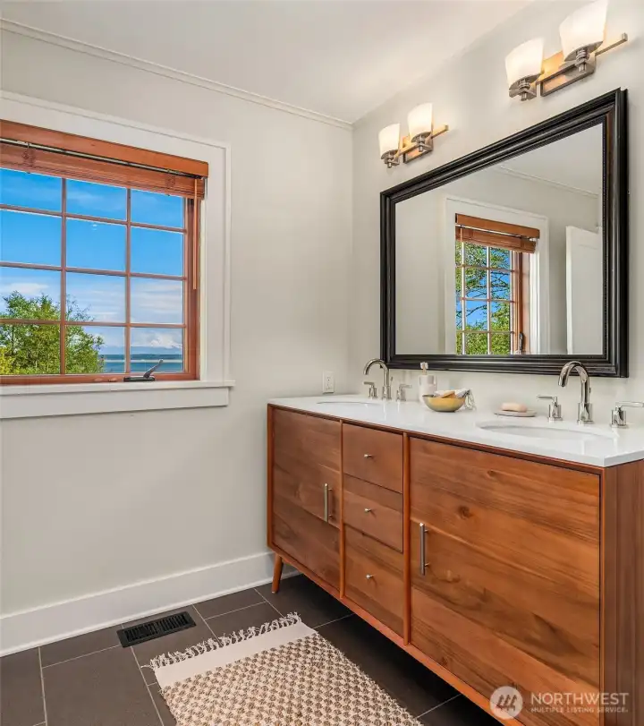The primary bathroom offers a new, double-sink vanity.