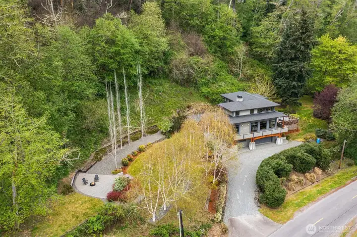 A spectacular view of the sprawling 2.66 acre property. Mature landscaping provides privacy from road traffic.