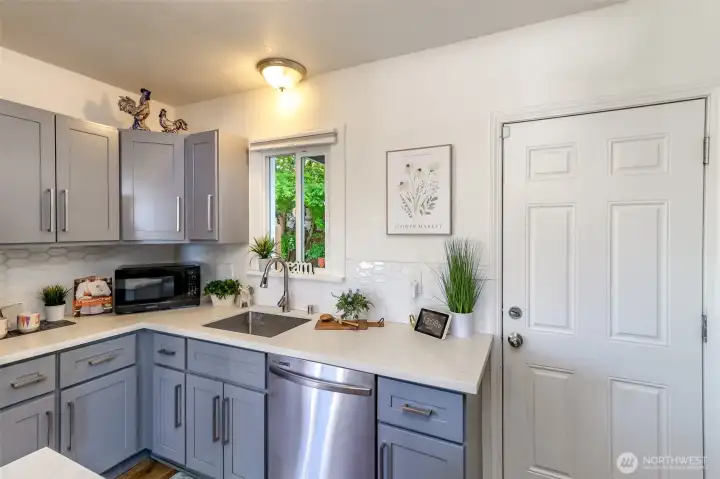 Back door leads to charming patio & orivate garage!