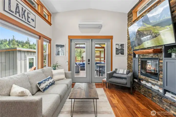 Light-filled living area with vaulted ceilings, warm wood finishes and access to the covered deck. Light-filled living area with vaulted ceilings, warm wood finishes and access to the covered deck.