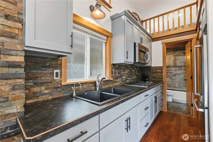 Contemporary kitchen design with textured backsplash and generous workspace. Contemporary kitchen design with textured backsplash and generous workspace.