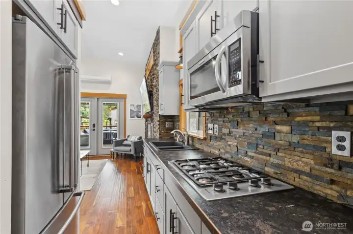 Modern kitchen with gas cooktop, custom cabinetry, and durable finishes. Modern kitchen with gas cooktop, custom cabinetry, and durable finishes.