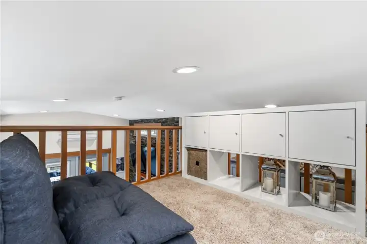 Upper loft with built-in storage and views overlooking the main living area below. Upper loft with built-in storage and views overlooking the main living area below.
