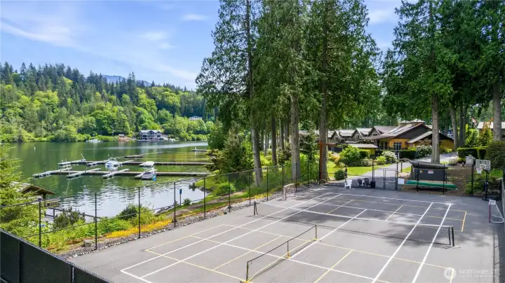 Sport court with lake views offers additional recreational amenities within the gated waterfront community. Sport court with lake views offers additional recreational amenities within the gated waterfront community.