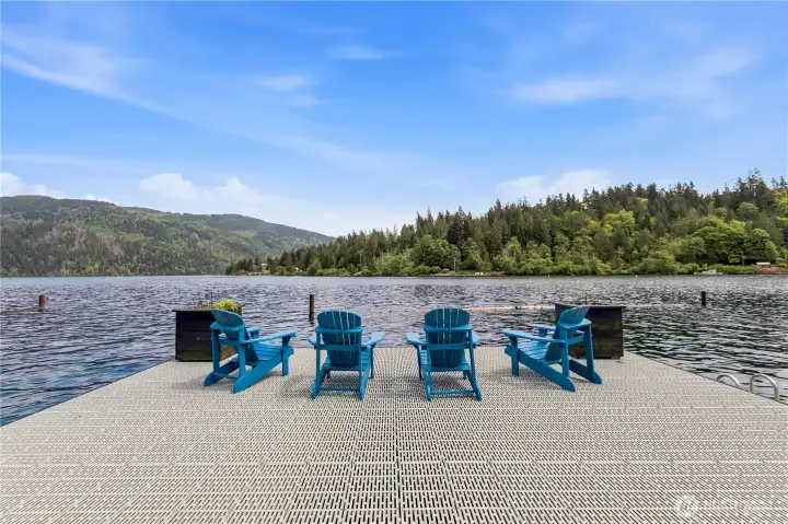 Large lakefront dock area offers panoramic water and mountain views with space to lounge and enjoy the outdoors. Large lakefront dock area offers panoramic water and mountain views with space to lounge and enjoy the outdoors.