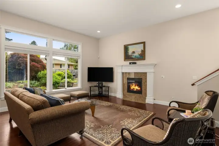 Living room features expansive ceilings, gas fireplaces, and large windows that overlook your private backyard.