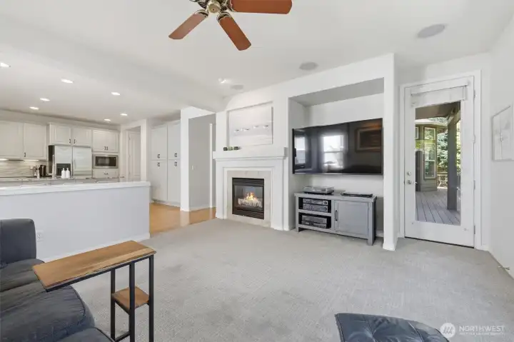 Living space off the kitchen with gas fireplace and access to the back deck.