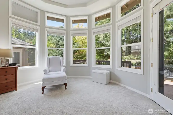 Sitting area in the primary also has an access door to the back deck.