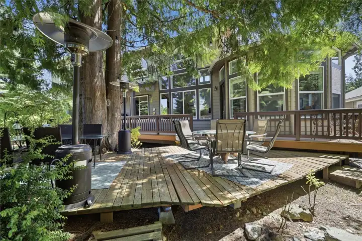 Amazing second deck built into the trees with two dining areas is excellent for entertaining.