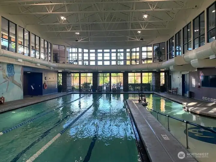 Here is the clubhouse pool with second-story jogging track.  Other features include fitness center, yoga room, spa, pickleball and tennis courts, parks, and miles of nature trails.