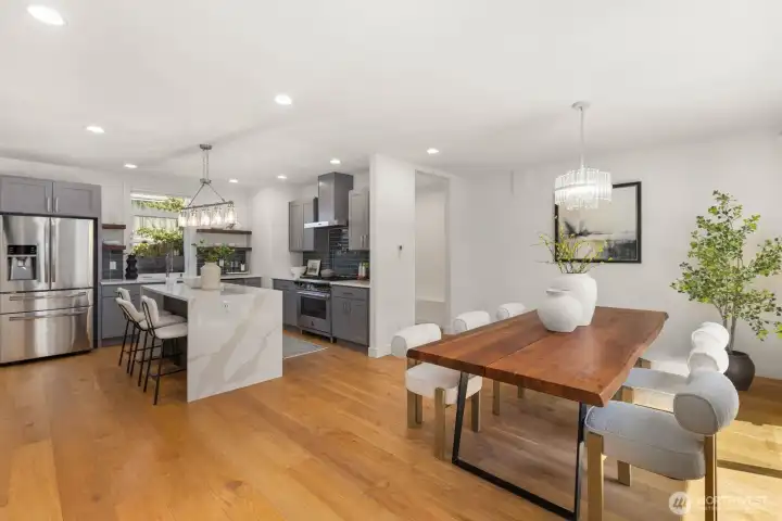 Open main floor with generous dining space and a chef’s kitchen centered around a waterfall island. Open main floor with generous dining space and a chef’s kitchen centered around a waterfall island.