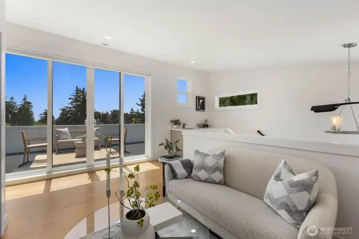 Flexible third-floor lounge with direct rooftop access and space to work or unwind. Flexible third-floor lounge with direct rooftop access and space to work or unwind.