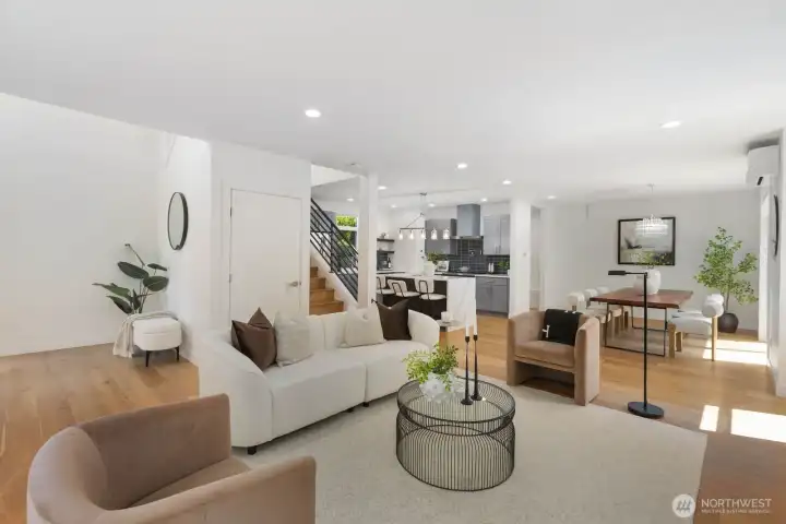 The open main floor seamlessly connects the living room, dining area, and kitchen. The open main floor seamlessly connects the living room, dining area, and kitchen.