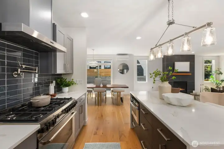 Another view of the kitchen highlighting the island, range, and open sightlines. Another view of the kitchen highlighting the island, range, and open sightlines.