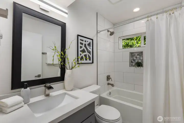 Full hall bath with a tiled tub and shower surround. Full hall bath with a tiled tub and shower surround.
