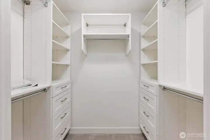 Custom walk-in closet with built-in shelving, drawers, and hanging space. Custom walk-in closet with built-in shelving, drawers, and hanging space.